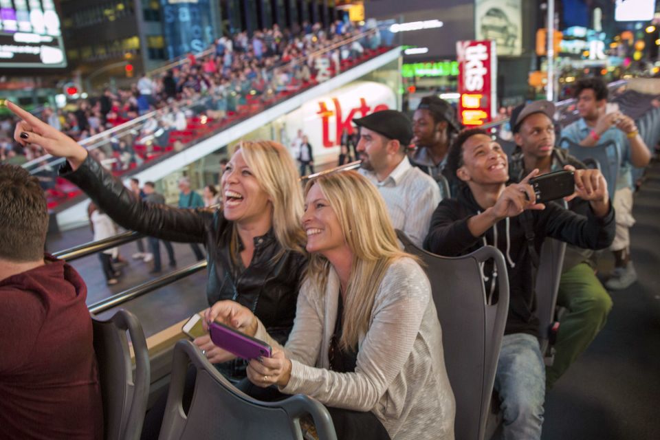 NYC: Sightseeing Night Tour by Open-Top Bus with Live Guide - Downtown landmarks on the illuminated route: Empire State and Flatiron in motion
