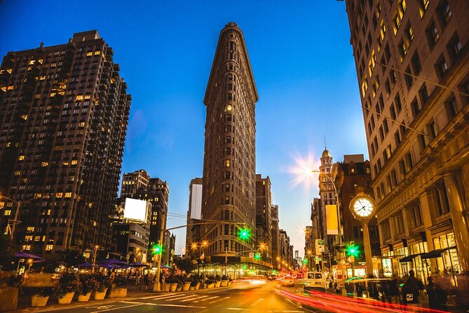 Skyline Night Bus Audio Narrated Tour Experience - Bryant Park at night: trees, lights, and a calmer Midtown pause