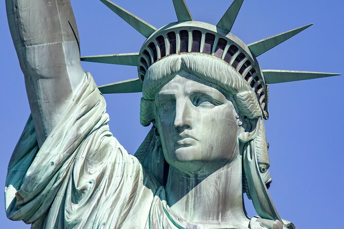 Statue of Liberty & Ellis Island Guided Tour with Ferry Transfers - Ferry ride and Liberty Island: seeing the Statue of Liberty from smart angles